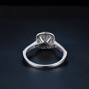 Macro shot of silver engagement ring with square-cut main stone and micro-pave diamonds
