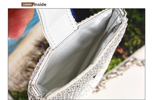 Detail view of the smooth silver satin interior lining of the rhinestone phone bag
