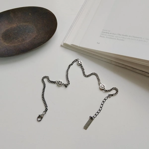 S925 Sterling silver chain anklet with smiling face charms on minimalist white background