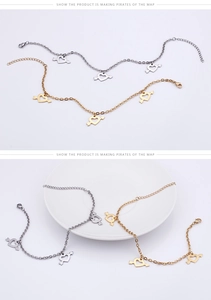 Detailed view of heart arrow charms on titanium steel anklets in gold and silver finish