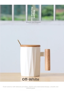 Detail of matte white ceramic mug with geometric facets and wooden handle on a table