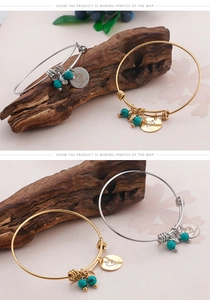 Detailed view of adjustable gold and silver bangles with turquoise beads and heart charms