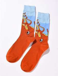 Detailed view of knitted cotton crew socks featuring orange octopus pattern and blue cuffs