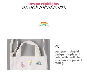 Detail of colorful enamel pins featuring a flamingo and rainbow on a canvas bag strap
