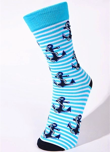Detail of nautical mid-calf socks with blue stripes and anchor patterns on white background
