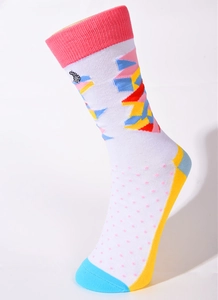 Detailed view of white cotton crew socks with pink polka dots and colorful geometric patterns