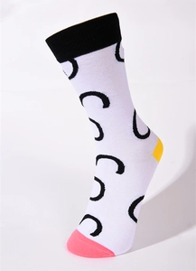 Detail of white cotton socks with black C-pattern, yellow heel and pink toe accents