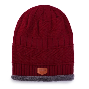 Winter knitted beanie in wine red with grey faux fur lining and leather patch detail