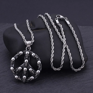 Hip hop punk style silver skull peace sign pendant with twist chain on stone background