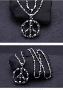 Detail of vintage punk skull peace sign pendant with silver twisted rope chain