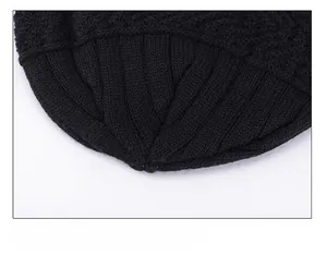 Close-up of radial stitching and heavy knit texture on the top of black beanie