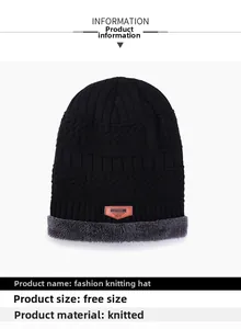 Detail view of the black knit hat featuring soft grey plush lining and a leather brand patch