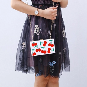 White acrylic square clutch bag with red cherry prints and golden chain strap