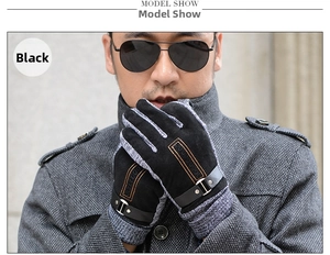 Detail of men's winter leather gloves showing gray knit patchwork and orange stitching