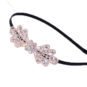 Sparkling rhinestone rose gold bow headband on a thin black band for girls