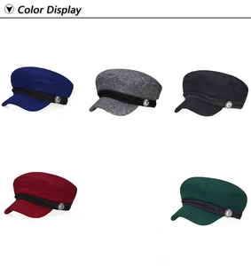 Detail view of newsboy hats in five colors with woven bands and metal button accents