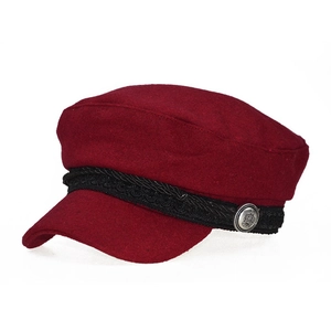 Close-up of burgundy wool newsboy cap with woven strap and silver crown metal button