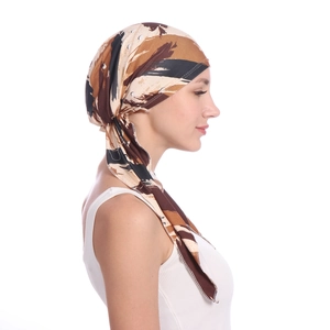 Detail of printed turban hat showing silky abstract brown stripes and adjustable tie back