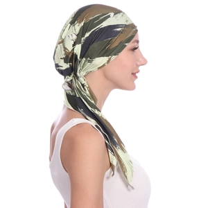 Detail of green camouflage headwrap with tie-back knot on model against white background