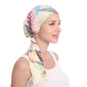 Side view of printed milk silk turban hat with colorful fern leaf pattern and long ties