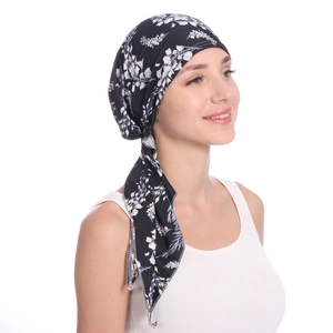 Detail shot of the side tie design on a black and white floral print head wrap