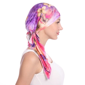 Detail of floral printed headscarf showing vibrant purple and pink floral patterns