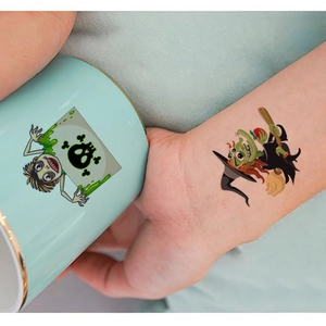 Detailed view of zombie and witch temporary tattoos on wrist and ceramic mug surfaces