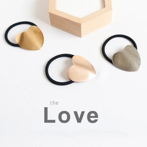Set of three chic metal heart hair ties in gold, rose gold, and silver finishes