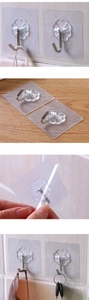 Detailed view of clear adhesive hook with stainless steel hook and petal base design