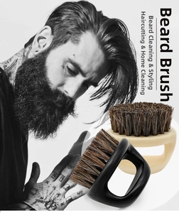 Detail showing ring-handle boar bristle brushes for beard styling and barber hair cleaning