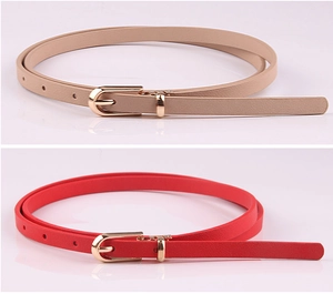 Detail of beige and red slim faux leather belts with polished gold pin buckles