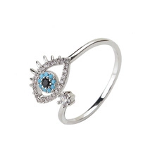 Close-up of silver evil eye ring with blue beads and inlaid clear crystals