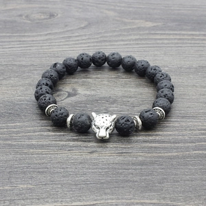 Macro shot of silver leopard head bead on black volcanic stone elastic bracelet