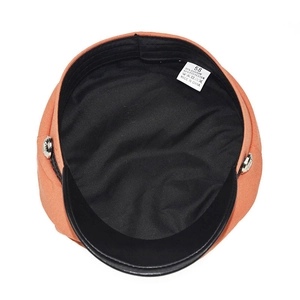 Internal view of orange newsboy hat showing wash label with 58cm size and fabric info
