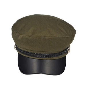 Close-up of military baker boy hat featuring olive cotton top and black faux leather brim