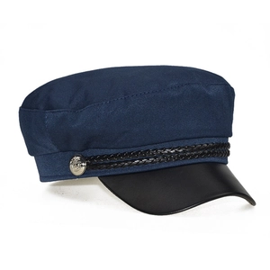 Detail of navy blue peaked hat featuring black leather brim and silver metal buttons