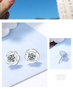 Close-up of silver flower stud earrings with sparkling cubic zirconia center and back posts