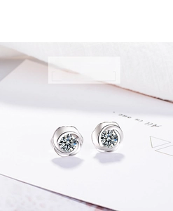 Macro detail of silver rose stud earrings featuring sparkling round-cut cubic zirconia stones
