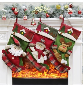 Three classic Christmas stockings with Santa, snowman and reindeer on a white mantel