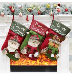 Three festive Christmas stockings featuring Santa, Snowman, and Reindeer hung by a fireplace