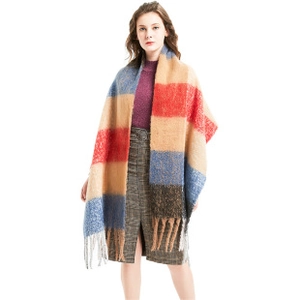 Close-up of color-block plaid knit scarf featuring fringe tassels and thick texture