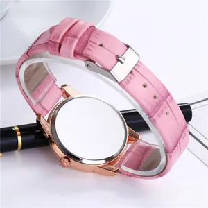 Detail of pink croc-embossed leather strap and rose gold case on women's quartz watch