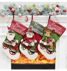 Detailed view of Christmas stockings with cycling Santa and Reindeer on a cozy fireplace