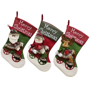 Three Christmas stockings featuring Santa, Snowman, and Reindeer on bicycles with Merry Christmas