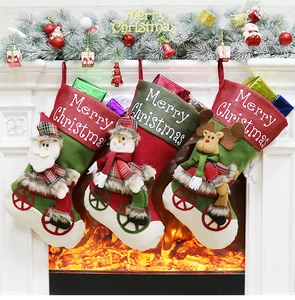 Three Christmas stockings with Santa, Snowman and Reindeer appliques hanging on a fireplace