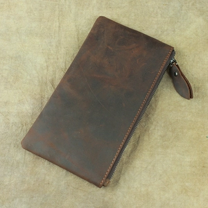 Close-up of vintage dark brown crazy horse leather wallet with a premium zipper closure