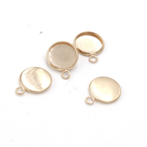 Macro view of gold-plated stainless steel round pendant trays and bezel settings