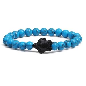 Close-up of sky blue marbled beads with a black sea turtle charm on the bracelet