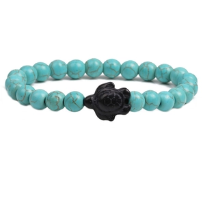 Lapis turquoise beaded bracelet featuring a black matte sea turtle charm centerpiece