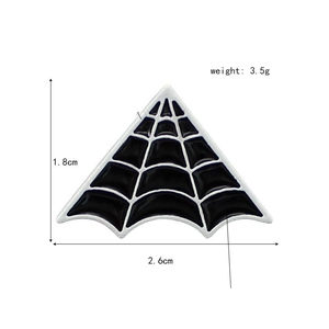 Macro shot of spider web enamel pin showing dimensions 1.8cm by 2.6cm and black white finish